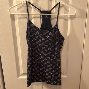 navy blue tank top with razor back. small purple flowers as details